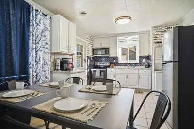 a kitchen with a table and chairs and a refrigerator at Angler's Cottage with Boat Parking by Lake Erie in Port Clinton