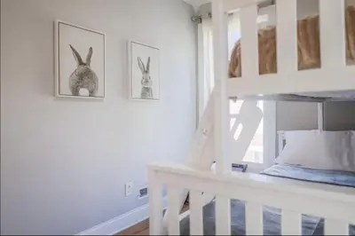 a white room with two pictures of rabbits on the wall at Spacious Home Downtown - Children's Hospital, Pets in Columbus