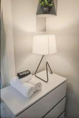 a white table with a lamp and towels on it at Spacious Home Downtown - Children's Hospital, Pets in Columbus