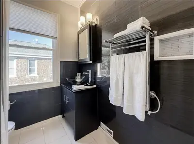 a bathroom with black walls and a sink and towels at Spacious Home Downtown - Children's Hospital, Pets in Columbus