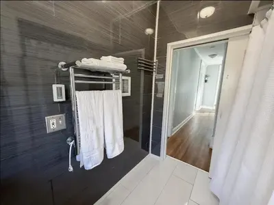a bathroom with a shower with white towels on a rack at Spacious Home Downtown - Children's Hospital, Pets in Columbus