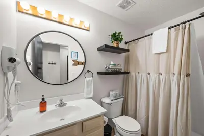a bathroom with a sink and a toilet and a mirror at Near Ark Private Parking Patio 2 bed 1&half Bath in Dry Ridge