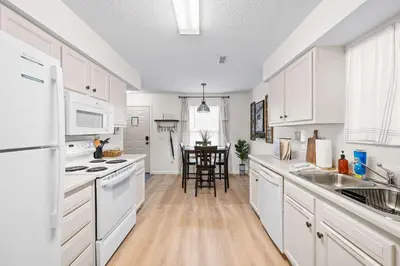 a white kitchen with white appliances and a table at Near Ark Private Parking Patio 2 bed 1&half Bath in Dry Ridge