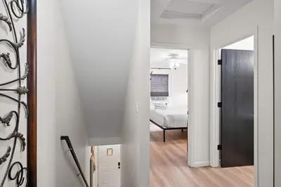 a hallway with a room with a bed and a mirror at Near Ark Private Parking Patio 2 bed 1&half Bath in Dry Ridge