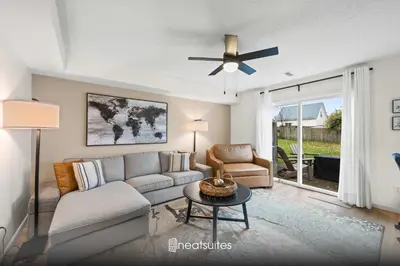a living room with a couch and a ceiling fan at Fire Ring Private Parking King Beds - Near Ark in Dry Ridge