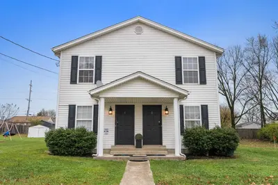 a white house with a black door at Fire Ring Private Parking King Beds - Near Ark in Dry Ridge