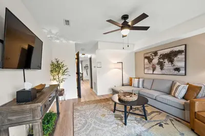 a living room with a couch and a ceiling fan at Entire Duplex Close to ark with Private Parking in Dry Ridge