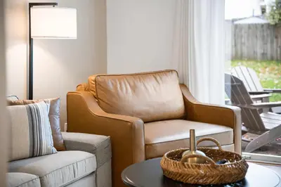 a living room with a chair and a table at Entire Duplex Close to ark with Private Parking in Dry Ridge