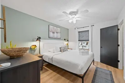 a bedroom with a bed and a ceiling fan at Entire Duplex Close to ark with Private Parking in Dry Ridge