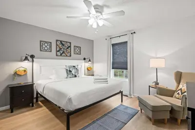 a bedroom with a bed and a ceiling fan at Entire Duplex Close to ark with Private Parking in Dry Ridge