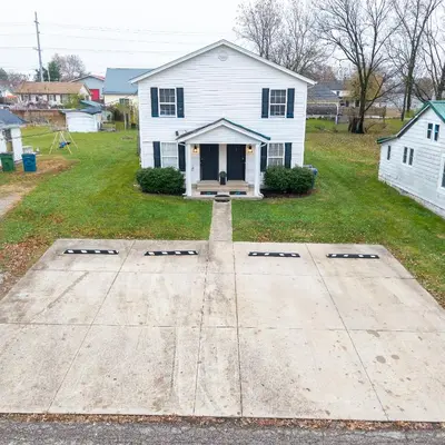 a house with a driveway in front of it at Entire Duplex Close to ark with Private Parking in Dry Ridge