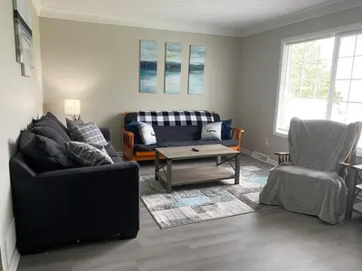 a living room with two couches and a coffee table at Beautiful Waterfront Ranch in Erie