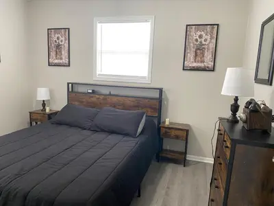 a bedroom with a large bed and a window at Beautiful Waterfront Ranch in Erie