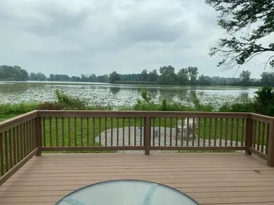 a wooden deck with a view of a lake at Beautiful Waterfront Ranch in Erie