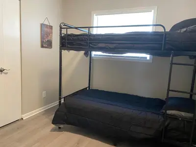 two bunk beds in a room with a window at Beautiful Waterfront Ranch in Erie