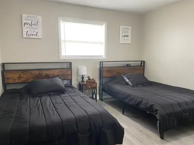 a bedroom with two beds and a window at Beautiful Waterfront Ranch in Erie