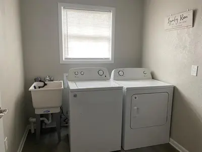 a laundry room with a washer and a sink at Beautiful Waterfront Ranch in Erie