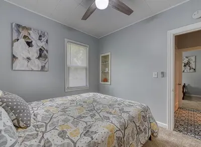 a bedroom with a bed and a ceiling fan at Beach Goers Paradise in Luna Pier
