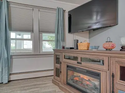 a living room with a fireplace and a flat screen tv at Beach Goers Paradise in Luna Pier