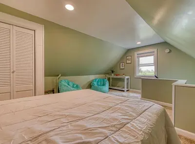 a bedroom with a large bed and a window at Beach Goers Paradise in Luna Pier