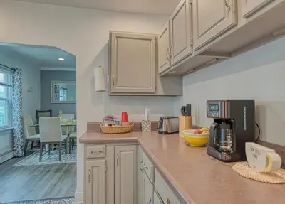 a kitchen with white cabinets and a counter top at Beach Goers Paradise in Luna Pier