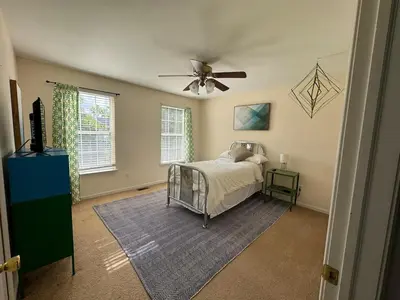 a bedroom with a bed and a ceiling fan at Battlefield Getaway in Monroe