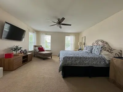 a bedroom with a bed and a ceiling fan at Battlefield Getaway in Monroe