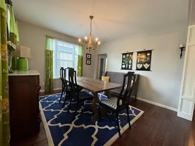a dining room with a wooden table and chairs at Battlefield Getaway in Monroe