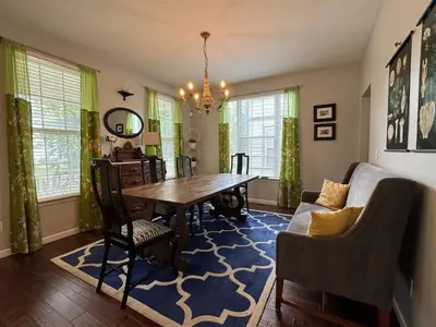 a dining room with a table and a couch at Battlefield Getaway in Monroe