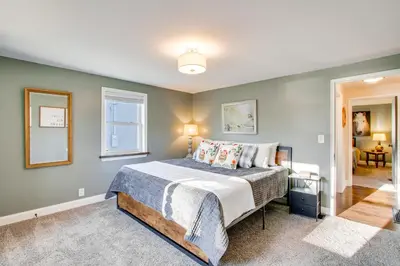 a bedroom with a bed and a window at Fully Updated! Zanesville Home with River Views in Zanesville