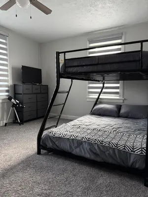 a bedroom with a bunk bed and a television at Rise & Shine in Richmond