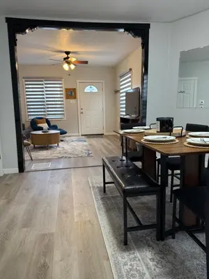 a living room with a table and a couch at Rise & Shine in Richmond