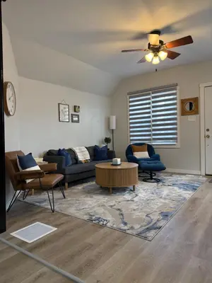 a living room with a couch and a ceiling fan at Rise & Shine in Richmond