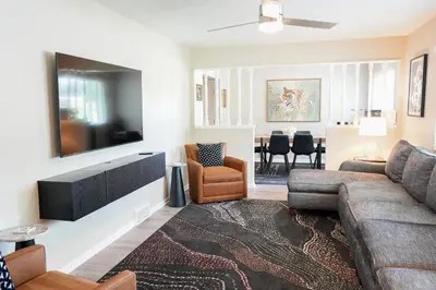 a living room with a couch and a flat screen tv at 3BR Retreat near BrewDog, games, and lots of space in Groveport