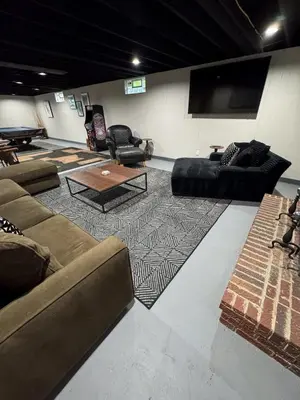 a living room with couches and a flat screen tv at 3BR Retreat near BrewDog, games, and lots of space in Groveport