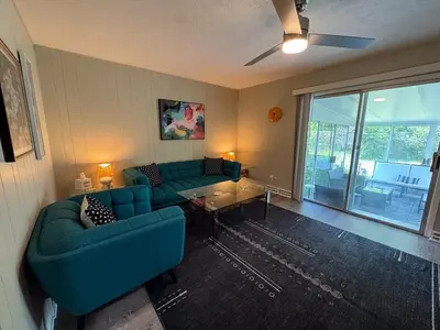 a living room with two blue couches and a table at 3BR Retreat near BrewDog, games, and lots of space in Groveport