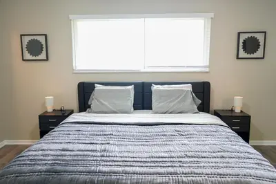 a bed in a bedroom with a large window at 3BR Retreat near BrewDog, games, and lots of space in Groveport