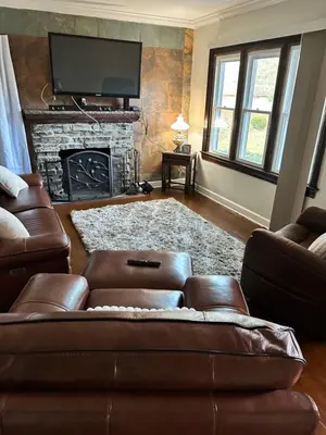a living room with a couch and a fireplace at Gem In The Heart of Mill Creek in Youngstown