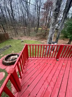 a red wooden bench with a fire pit on it at Gem In The Heart of Mill Creek in Youngstown