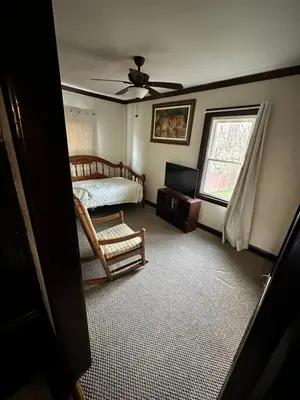 a bedroom with a bed and a window at Gem In The Heart of Mill Creek in Youngstown