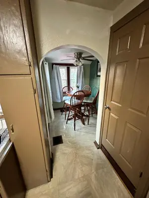 a hallway leading to a dining room with a table at Gem In The Heart of Mill Creek in Youngstown