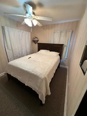a bedroom with a bed with a ceiling fan at Gem In The Heart of Mill Creek in Youngstown