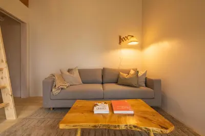 a living room with a couch and a coffee table at The Primrose in Logan