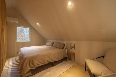 a small bedroom with a bed and a couch at The Primrose in Logan