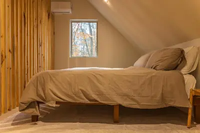 a bed in a room with a window at The Primrose in Logan