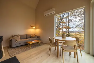 a living room with a couch and a table at The Primrose in Logan
