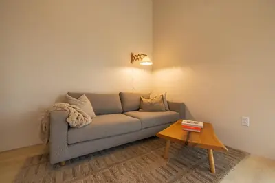 a living room with a couch and a table at The Klover in Logan