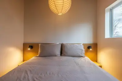 a bedroom with a bed with two pillows and a window at The Klover in Logan
