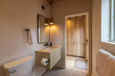 a bathroom with a sink and a toilet and a mirror at The Klover in Logan