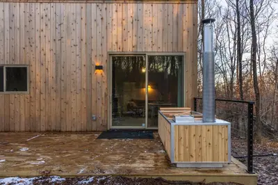 a wooden house with a glass door on a patio at The Klover in Logan